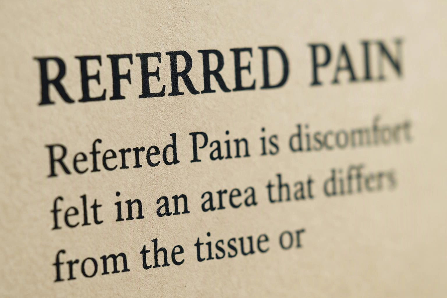 Close-up of a printed page showing the heading “REFERRED PAIN” and blurred body text